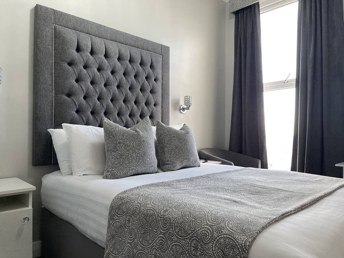 Double room with sea-toned throw at the Doric Hotel