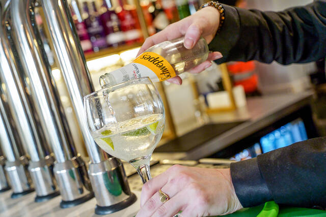 Gin and tonic poured at the bar
