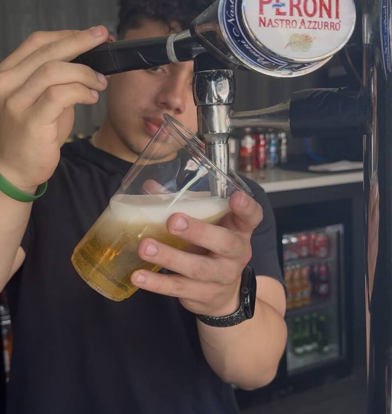 A Peroni being poured at the pool bar
